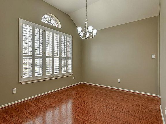 Formal Dining with hardwood floors and Plantation shutters