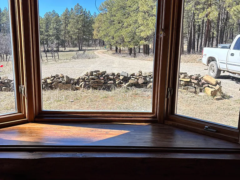 Bay window western view, the sun shines in to living space in later afternoon. Overlooks the front yard and driveway.