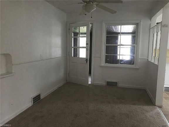 Dining room with enclosed back porch off of it.