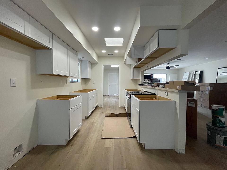 New Kitchen with white cabinets, quartz countertops, stainless steel appliances - fridge with water and ice dispenser, dishwasher, disposal, range and hood