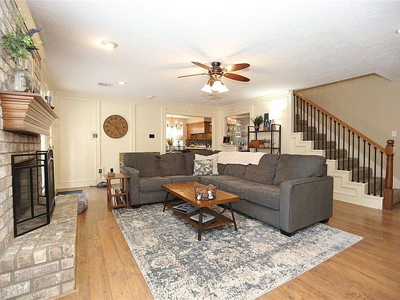 This spacious living room is anchored by the gas fireplace. A door to your left leads out to the pool/patio area, and towards the rear is a wet bar.