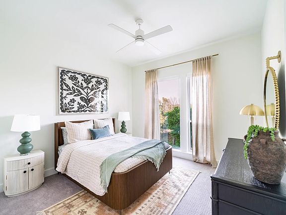 Bright and airy bedrooms at Modera Trailhead feature oversized windows and refined finishes, creating a restful retreat in Dallas.