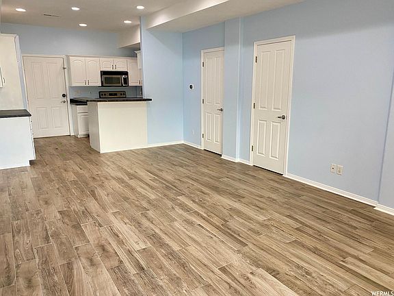 Main level with storage under stairs and half bathroom.