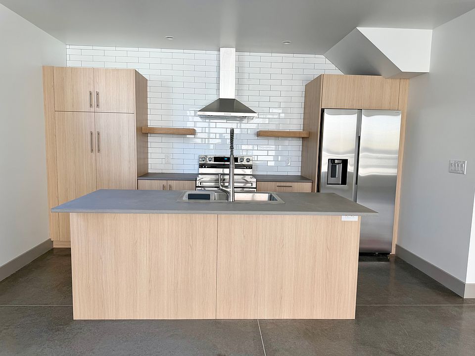 Well designed kitchen featuring stunning custom concrete countertops and floors.