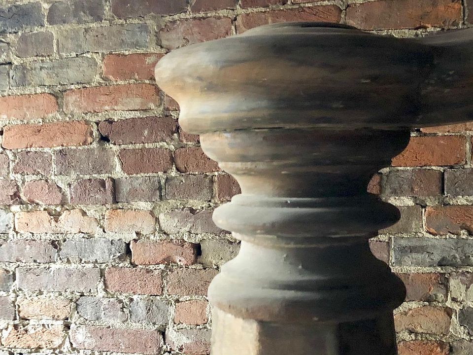 Historic banister & exposed brick entry