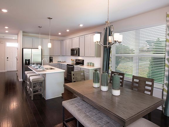Open-concept floorplan creates flow between dining and kitchen areas
