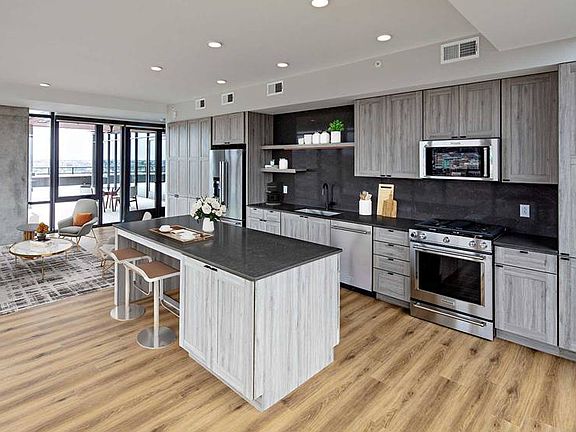 Penthouse-level Signature Collection apartment homes feature kitchens with upgraded finishes and appliances