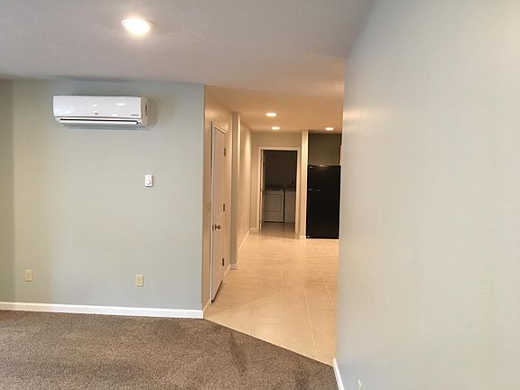 This view is from the living room. The entrance to the apartment is the door on the left. Straight ahead is the 2nd bathroom and laundry combination.