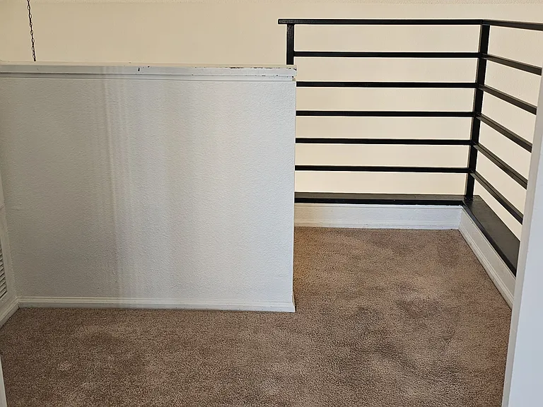 Loft-style space just outside the primary bedroom, offering a versatile area perfect for a home office, lounge, or additional living space.