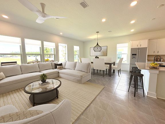 Virtually staged. Enjoy an open concept great room that has soft, contemporary finishes, welcoming views, and awesome sunlight.