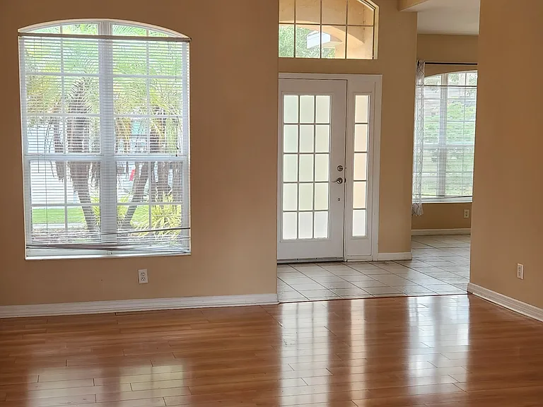 open floor plan of entrance, living area, and open side room