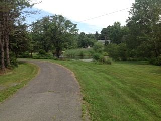 Front yard
						:
						View from front of house, with beautiful view of the pond.