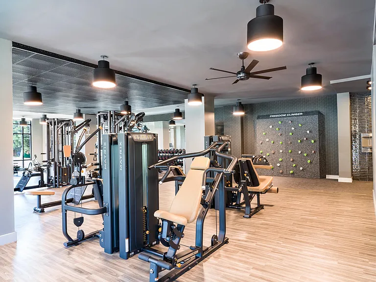 An expansive fitness studio with strength equipment, functional training areas, and room to move, designed to support varied workouts and daily routines.