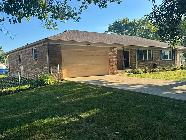 Duplex exterior. Small fenced in back yard.