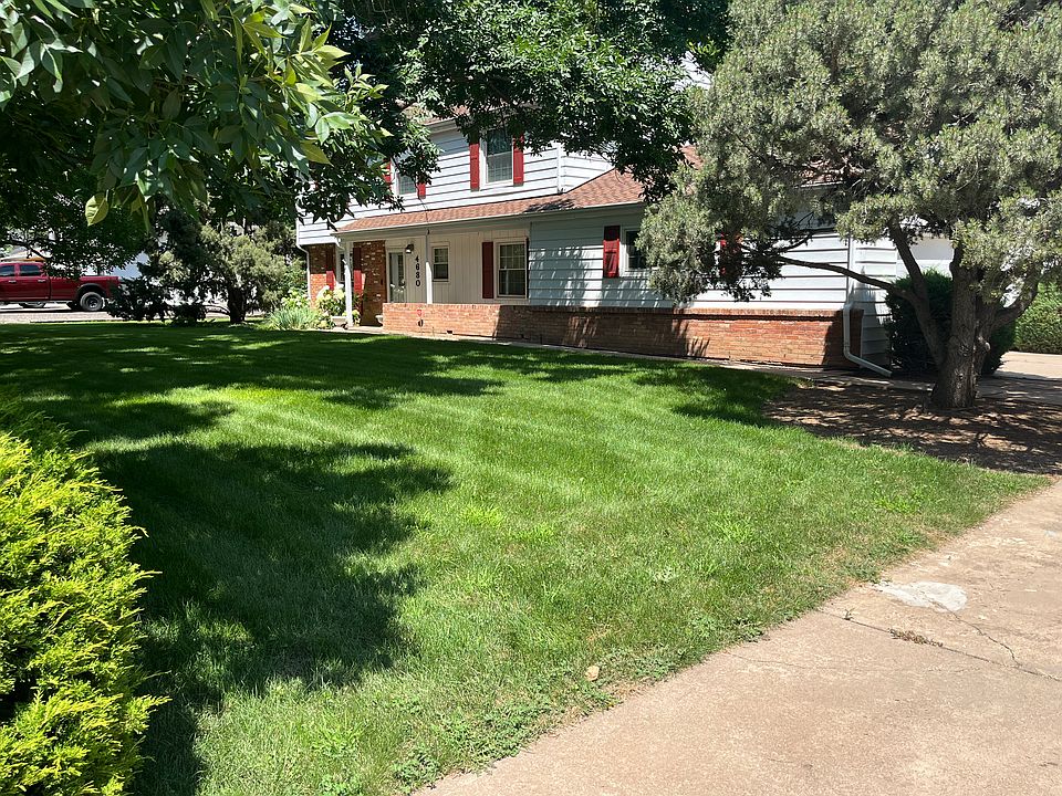 Front of house with a nice little patio behind the brick wall.