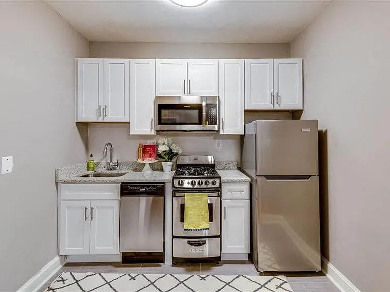 Studio kitchen with stainless steel appliances (staged)