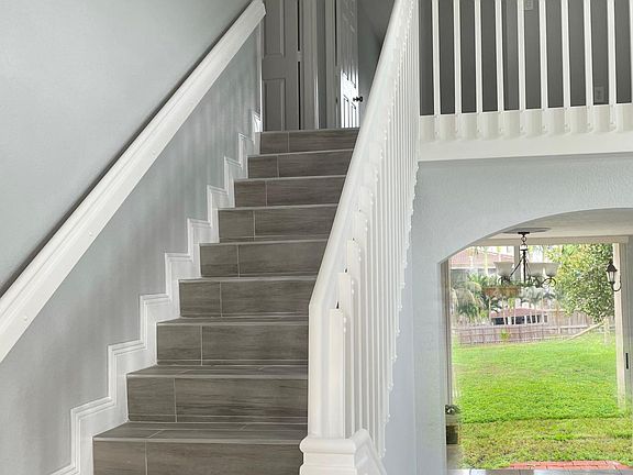 Stairs with view of dining room
