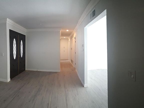 Front door on the left, entrance to den/study on the right