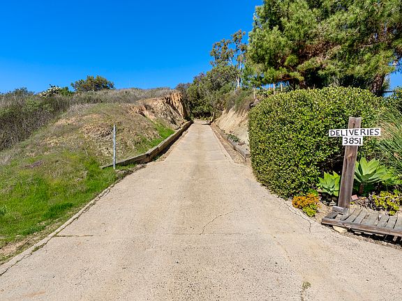 Private sandstone driveway entrance leading to the peaceful hilltop retreat.