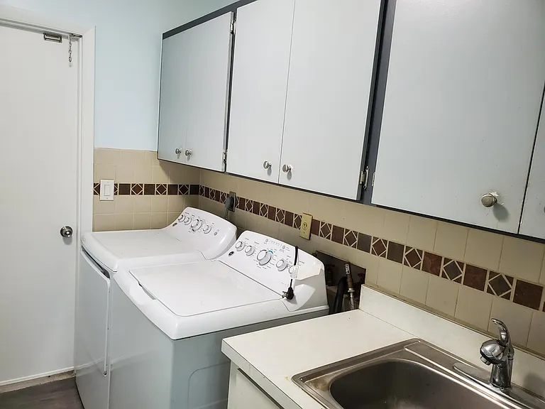 Laundry Room and Sink with cabinets and garage entrance