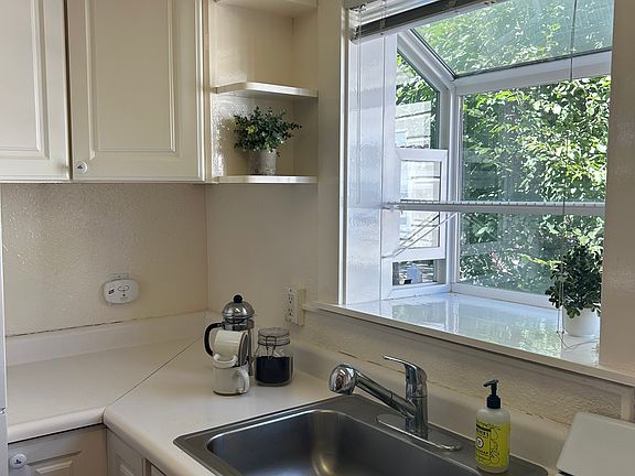 Meticulously maintained kitchen offers ample storage and shelving for all of your needs.