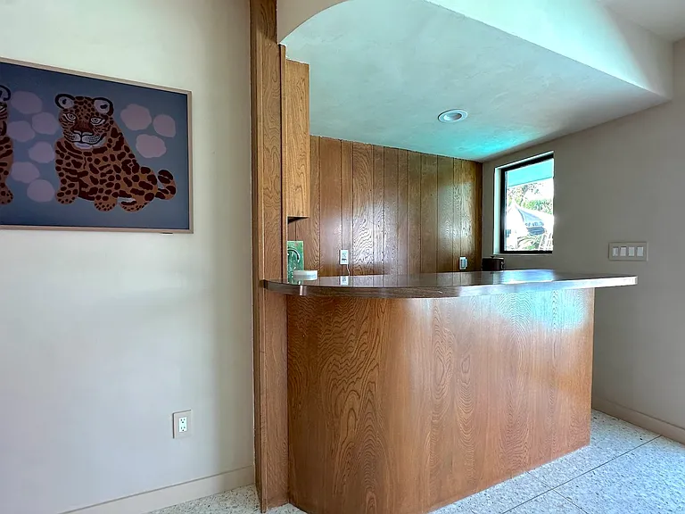 Bar off the living room next to sliding door opening to pool