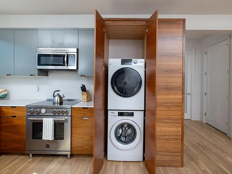 Stacked washer and dryer located next to the kitchen