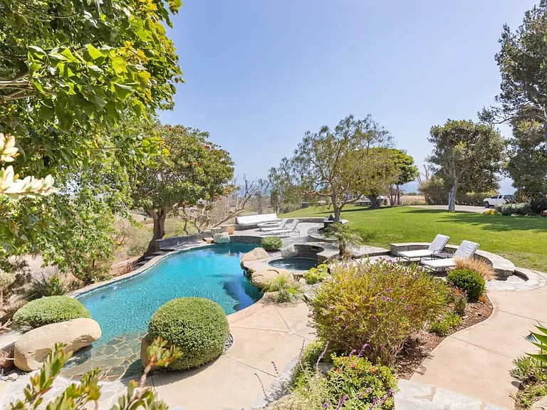 Wrapped with luscious lawns and green trees.