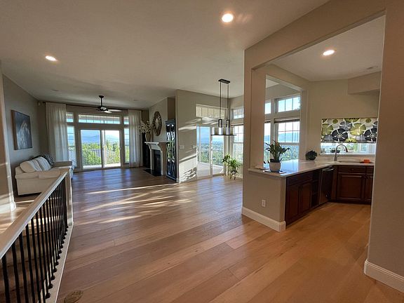 Open concept living room and dining area. Kitchen entrance to right.