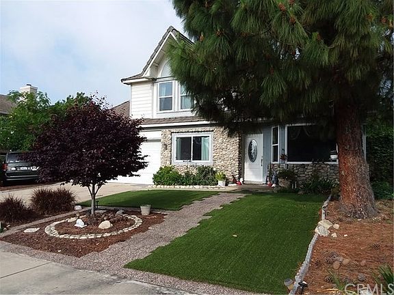 Lovely shade trees and artificial turf for low maintenance and water bills