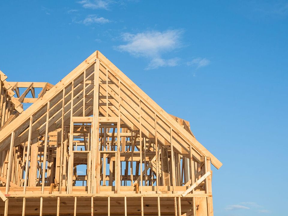 Close-up of gables roof on stick built home under construction and blue sky in Humble, Texas, USA. N