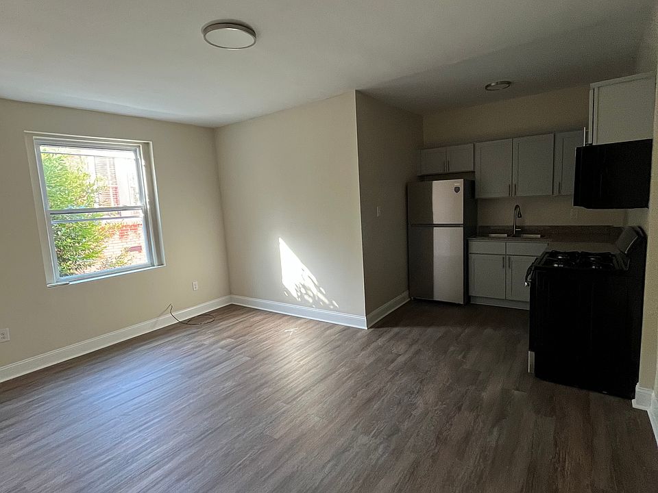 Newly renovated living room and kitchen, with dishwasher, oven/stove, and microwave