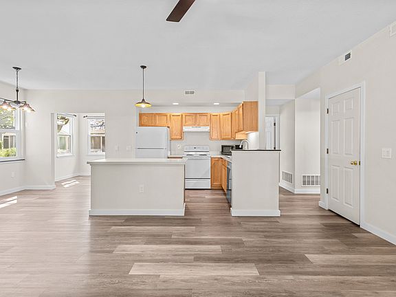 Open-concept with kitchen island, living room, and dining nook