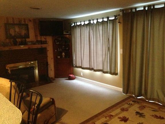 the other 1/2 of the living room area with fireplace