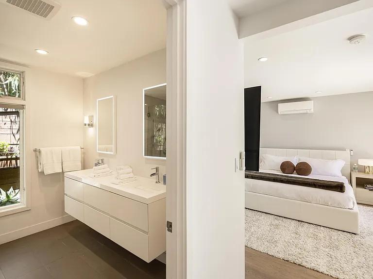 Refresh in the elegant ensuite bathroom, featuring modern amenities and sophisticated decor.