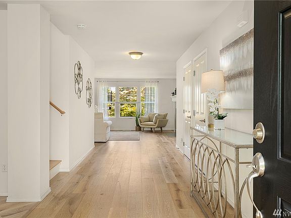 Wide-plank engineered hardwood floors provide simple elegance throughout.