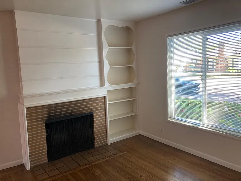 living room with fireplace and book shelves 11' 9" x 18'