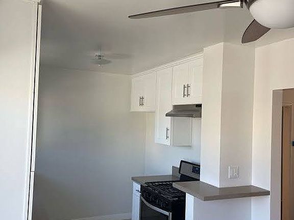 New range, vent hood, counter top space for cookware, pull-out spice storage, and room for a 36" wide refrigerator