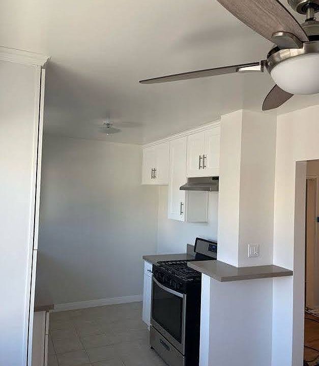New range, vent hood, counter top space for cookware, pull-out spice storage, and room for a 36" wide refrigerator