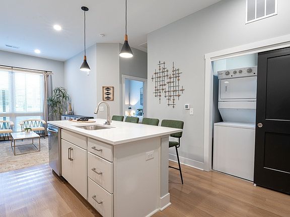 Quarry Trails Model washer/dryer, island kitchen and living room