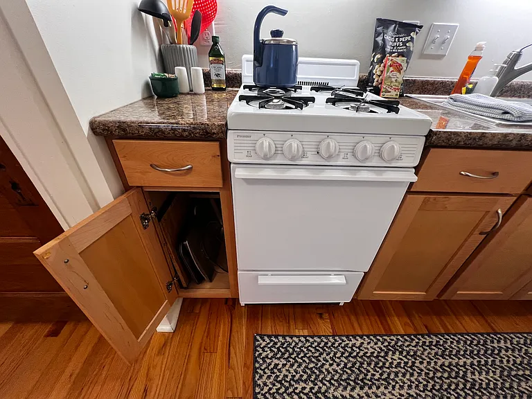 Cooking supplies in lower cabinet.