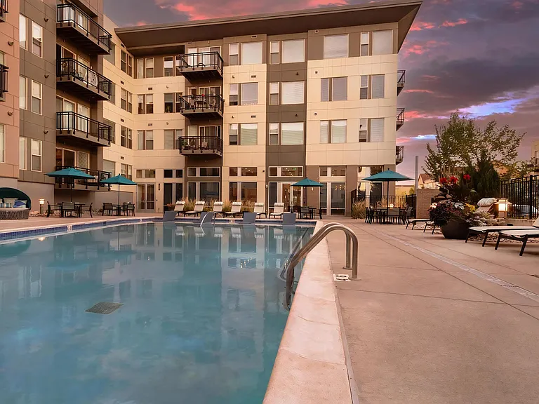Elegant Poolside Setting Framed by Apartment Buildings and Outdoor Seating