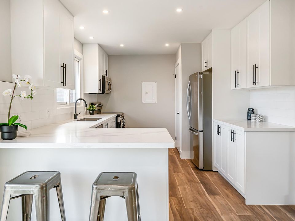 Dream Kitchen. You're standing in the dining room. Sliding door is to your left, front door is to your right. Note the closet past the fridge - that's where the washer and dryer are. Cupboard space below island, drawers beside oven. Lots of upper cabinets