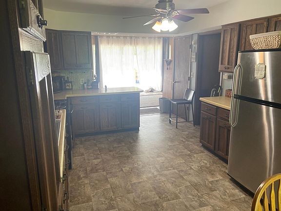 View of kitchen with living room in back.