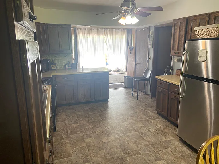 View of kitchen with living room in back.