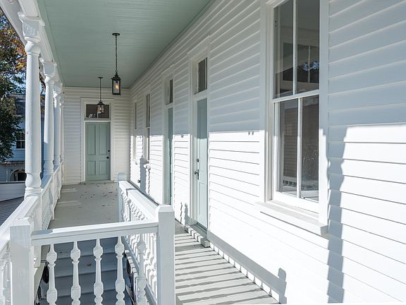 After entering through the privacy door and walking up the stairs, there is a shared porch. The porch is shared by the two upstairs apartments.