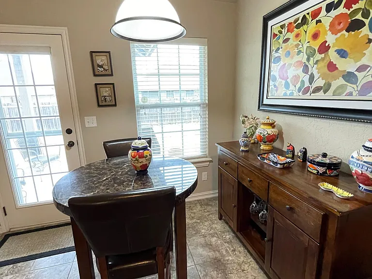 Eating area off kitchen with door to backyard and covered patio.