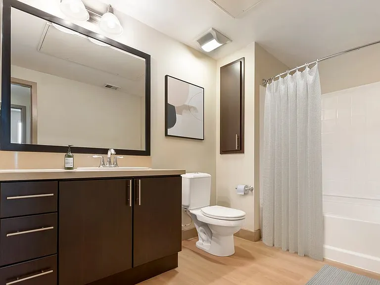Classic Collection II bath with beige quartz countertop, espresso cabinetry, and hard surface flooring
