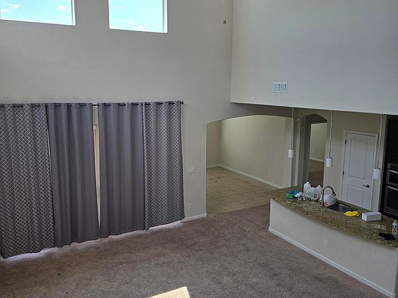 Looking from loft to living room into kitchen & dining