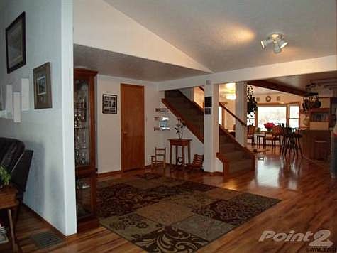 Large open kitchen with center island, pantry, desk area, and large eating area, all open and bright